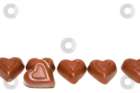 To use this stock image in your creative project, please select the size you need over to the right and click the "Add to Cart" button.
Your downloaded image will come with the Cutcaster watermark removed so don’t worry about the watermark you see on this page. Heart Chocolates stock photo, A line of delicious heart shaped milk chocolates. by Robert Byron
