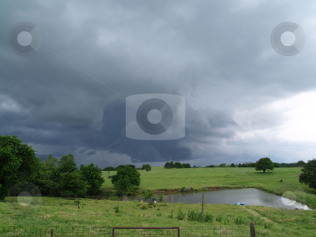 To use this stock image in your creative project, please select the size you need over to the right and click the "Add to Cart" button.
Your downloaded image will come with the Cutcaster watermark removed so don’t worry about the watermark you see on this page. A storms brewing stock photo, Out on the farm overlooking a pond with an approaching storm by Michelle Bergkamp