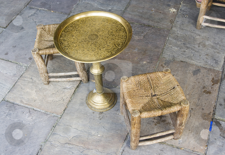 To use this stock image in your creative project, please select the size you need over to the right and click the "Add to Cart" button.
Your downloaded image will come with the Cutcaster watermark removed so don’t worry about the watermark you see on this page. Vintage Table and chairs stock photo, Arab vintage table and chairs made of brass and wood by Ivan Montero