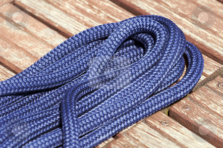 To use this stock image in your creative project, please select the size you need over to the right and click the "Add to Cart" button.
Your downloaded image will come with the Cutcaster watermark removed so don’t worry about the watermark you see on this page. Nautical rope stock photo, Close-up of a blue rope on a wooden jetty by Massimiliano Leban