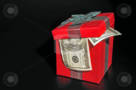 To use this stock image in your creative project, please select the size you need over to the right and click the "Add to Cart" button.
Your downloaded image will come with the Cutcaster watermark removed so don’t worry about the watermark you see on this page. Christmas Present stock photo, A Christmas box with 100 dollar bills. by Robert Byron