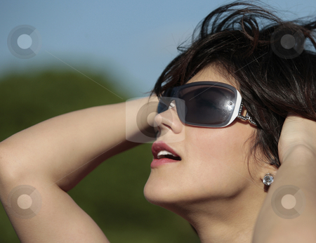 To use this stock image in your creative project, please select the size you need over to the right and click the "Add to Cart" button.
Your downloaded image will come with the Cutcaster watermark removed so don’t worry about the watermark you see on this page. Woman in sunglasses stock photo, Profile view of a beautiful young lady with dark sun glasses outdoor looking at the sun smiling by Claudia Veja