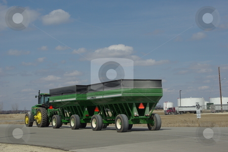 To use this stock image in your creative project, please select the size you need over to the right and click the "Add to Cart" button.
Your downloaded image will come with the Cutcaster watermark removed so don’t worry about the watermark you see on this page. Tractor towing grain wagons stock photo, A John Deere tractor tows two big grain wagons into the Fairbank, Iowa biofues plant. Iowa leads the nation in the number of biofuel production facilities making ethanol from corn with 25 now in operation. Seventeen more plants are under construction or planning stages (photo 04/02/2008). by Dennis Thomsen