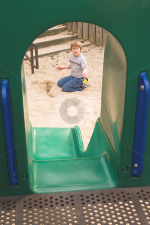 To use this stock image in your creative project, please select the size you need over to the right and click the "Add to Cart" button.
Your downloaded image will come with the Cutcaster watermark removed so don’t worry about the watermark you see on this page. Boy Playing at a Playground stock photo, A little boy digging in the sand at a playground. by Robert Byron