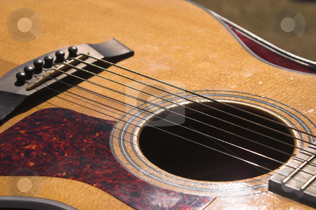 To use this stock image in your creative project, please select the size you need over to the right and click the "Add to Cart" button.
Your downloaded image will come with the Cutcaster watermark removed so don’t worry about the watermark you see on this page. Guitar stock photo, A close-up view of an acoustic guitar. by Robert Byron