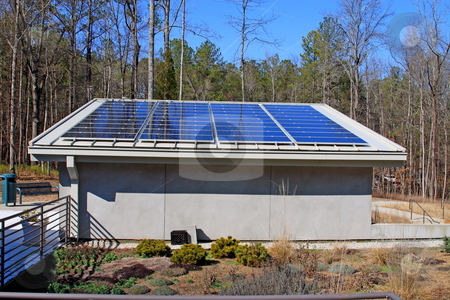 To use this stock image in your creative project, please select the size you need over to the right and click the "Add to Cart" button.
Your downloaded image will come with the Cutcaster watermark removed so don’t worry about the watermark you see on this page. Solar Power stock photo, Solar panels generating power for state park visitors building by Jack Schiffer
