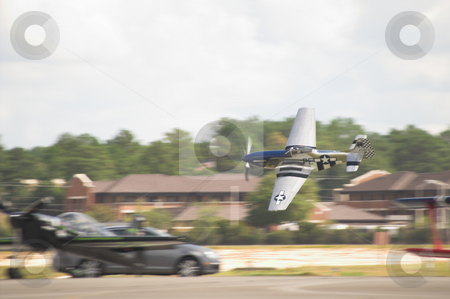 To use this stock image in your creative project, please select the size you need over to the right and click the "Add to Cart" button.
Your downloaded image will come with the Cutcaster watermark removed so don’t worry about the watermark you see on this page. P-51 Mustang stock photo, A historic WWII P-51 Mustang in flight. by Robert Byron