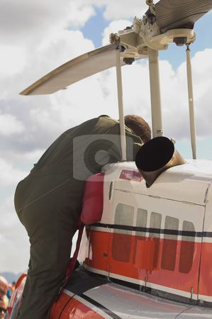 To use this stock image in your creative project, please select the size you need over to the right and click the "Add to Cart" button.
Your downloaded image will come with the Cutcaster watermark removed so don’t worry about the watermark you see on this page. Helicopter Mechanic stock photo, A specialized mechanic working on a US Coast Guard helicopter. by Robert Byron