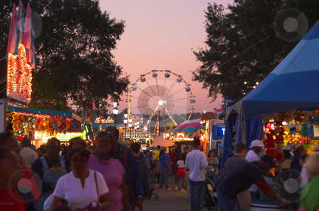 To use this stock image in your creative project, please select the size you need over to the right and click the "Add to Cart" button.
Your downloaded image will come with the Cutcaster watermark removed so don’t worry about the watermark you see on this page. Ferris Wheel at Dusk stock photo, A brightly lit ferris wheel in motion at dusk. by Robert Byron