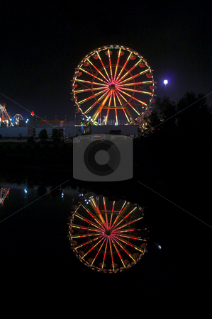 To use this stock image in your creative project, please select the size you need over to the right and click the "Add to Cart" button.
Your downloaded image will come with the Cutcaster watermark removed so don’t worry about the watermark you see on this page. Ferris Wheel stock photo, A large ferris wheel or big wheel at a fair. by Robert Byron