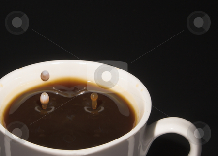 To use this stock image in your creative project, please select the size you need over to the right and click the "Add to Cart" button.
Your downloaded image will come with the Cutcaster watermark removed so don’t worry about the watermark you see on this page. Milk Splash in Coffee stock photo, Drop of milk splashing into a cup of coffee. by Robert Byron