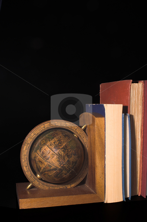 To use this stock image in your creative project, please select the size you need over to the right and click the "Add to Cart" button.
Your downloaded image will come with the Cutcaster watermark removed so don’t worry about the watermark you see on this page. Globe Bookend stock photo, A globe on a bookend holding up books. by Robert Byron