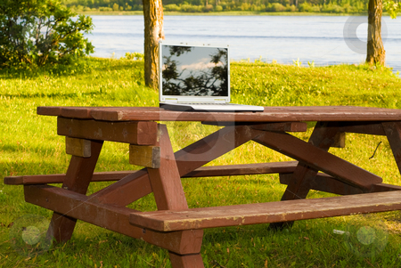 To use this stock image in your creative project, please select the size you need over to the right and click the "Add to Cart" button.
Your downloaded image will come with the Cutcaster watermark removed so don’t worry about the watermark you see on this page. Laptop In The Park stock photo, A laptop computer resting on a picnic table outside in a park by Richard Nelson