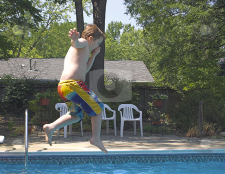 To use this stock image in your creative project, please select the size you need over to the right and click the "Add to Cart" button.
Your downloaded image will come with the Cutcaster watermark removed so don’t worry about the watermark you see on this page. Boy Jumping In a Pool stock photo, A little boy jumping into a pool. by Robert Byron