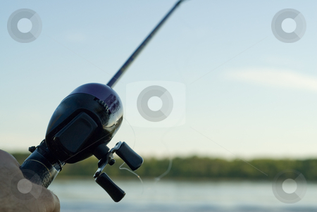 To use this stock image in your creative project, please select the size you need over to the right and click the "Add to Cart" button.
Your downloaded image will come with the Cutcaster watermark removed so don’t worry about the watermark you see on this page. Fishing rod stock photo, Someone fishing with a fishing rod and reel in a lake by Richard Nelson