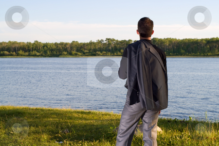To use this stock image in your creative project, please select the size you need over to the right and click the "Add to Cart" button.
Your downloaded image will come with the Cutcaster watermark removed so don’t worry about the watermark you see on this page. After Work stock photo, A young businessman at the lake after work by Richard Nelson