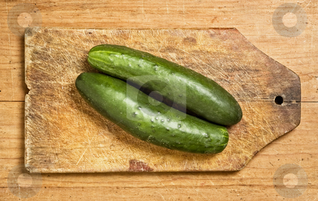 To use this stock image in your creative project, please select the size you need over to the right and click the "Add to Cart" button.
Your downloaded image will come with the Cutcaster watermark removed so don’t worry about the watermark you see on this page. Two cucumbers stock photo, Two cucumbers on a wooden kitchen table. by Pablo Caridad