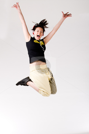 To use this stock image in your creative project, please select the size you need over to the right and click the "Add to Cart" button.
Your downloaded image will come with the Cutcaster watermark removed so don’t worry about the watermark you see on this page. Jumping on the music stock photo, Young girl enjoying the music and dance on it by Frenk and Danielle Kaufmann