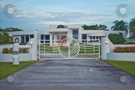 To use this stock image in your creative project, please select the size you need over to the right and click the "Add to Cart" button.
Your downloaded image will come with the Cutcaster watermark removed so don’t worry about the watermark you see on this page. Modern Gated House stock photo, A modern suburban gated house by Robert Cabrera