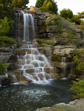 To use this stock image in your creative project, please select the size you need over to the right and click the "Add to Cart" button.
Your downloaded image will come with the Cutcaster watermark removed so don’t worry about the watermark you see on this page. Waterfall stock photo, Waterfall at the botanical garden of Montreal city by Vlad Podkhlebnik