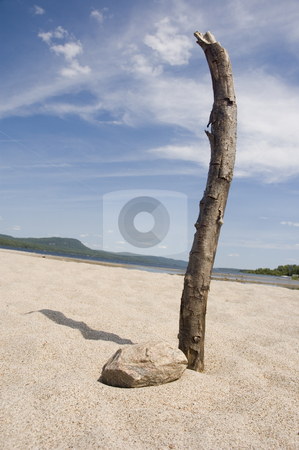 To use this stock image in your creative project, please select the size you need over to the right and click the "Add to Cart" button.
Your downloaded image will come with the Cutcaster watermark removed so don’t worry about the watermark you see on this page. Beach stock photo, A branch of a dead tree and a rock in the sand by Vlad Podkhlebnik