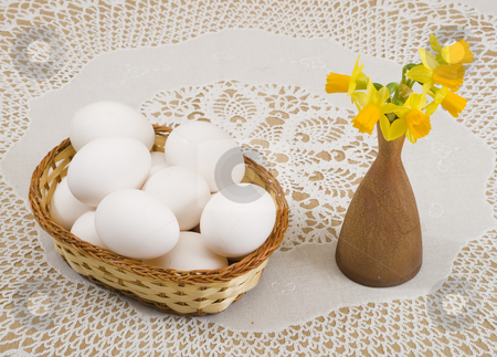 To use this stock image in your creative project, please select the size you need over to the right and click the "Add to Cart" button.
Your downloaded image will come with the Cutcaster watermark removed so don’t worry about the watermark you see on this page. Easter stock photo, A basket of eggs and yellow daffodils in a vase by Petr Koudelka