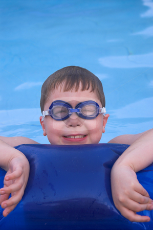 To use this stock image in your creative project, please select the size you need over to the right and click the "Add to Cart" button.
Your downloaded image will come with the Cutcaster watermark removed so don’t worry about the watermark you see on this page. Boy Swimming stock photo, A little boy resting on the edge of a pool. by Robert Byron