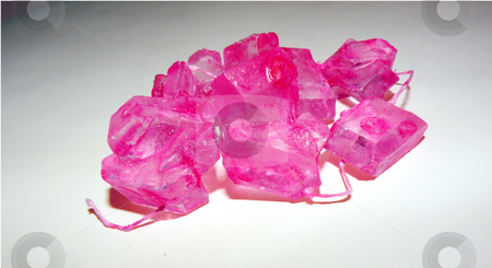 To use this stock image in your creative project, please select the size you need over to the right and click the "Add to Cart" button.
Your downloaded image will come with the Cutcaster watermark removed so don’t worry about the watermark you see on this page. Pink rock candy stock photo, A string of pink rock candy by Rob Wright