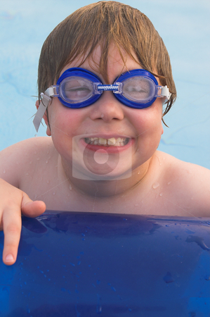 To use this stock image in your creative project, please select the size you need over to the right and click the "Add to Cart" button.
Your downloaded image will come with the Cutcaster watermark removed so don’t worry about the watermark you see on this page. Boy Swimming stock photo, A little boy resting on the edge of a pool. by Robert Byron