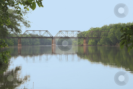 To use this stock image in your creative project, please select the size you need over to the right and click the "Add to Cart" button.
Your downloaded image will come with the Cutcaster watermark removed so don’t worry about the watermark you see on this page. Train Trestle stock photo, An old vintage train trestle over a river. by Robert Byron