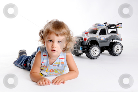 To use this stock image in your creative project, please select the size you need over to the right and click the "Add to Cart" button.
Your downloaded image will come with the Cutcaster watermark removed so don’t worry about the watermark you see on this page. Boy and Toy Car stock photo, Little Curly-headed Boy and Toy Car by Valeriy Mazur