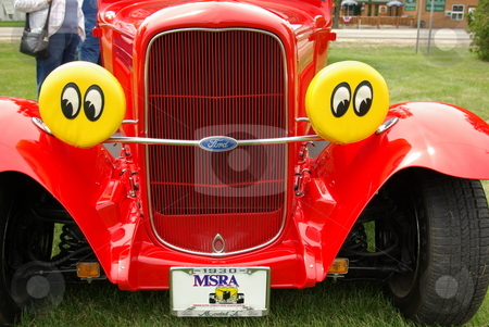 To use this stock image in your creative project, please select the size you need over to the right and click the "Add to Cart" button.
Your downloaded image will come with the Cutcaster watermark removed so don’t worry about the watermark you see on this page. 1930 Red Ford Coupe with Eyes stock photo, A red 1930 Ford coupe streetrod with special headlamp covers grabbed a lot of attention at the spring Pequot Lakes, MN Classic Car Show. by Dennis Thomsen