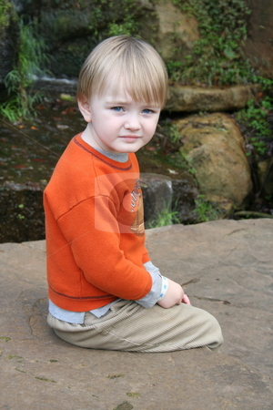 To use this stock image in your creative project, please select the size you need over to the right and click the "Add to Cart" button.
Your downloaded image will come with the Cutcaster watermark removed so don’t worry about the watermark you see on this page. Little Boy Sitting by Waterfall stock photo, Little boy sitting on the rocks by a waterfall by Debbie Hayes