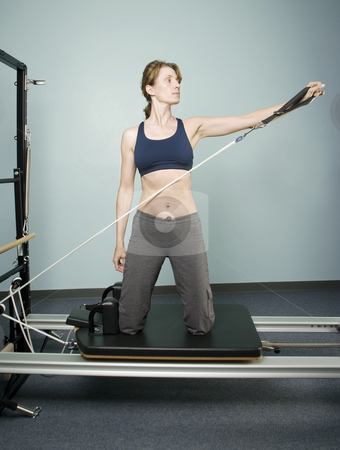 To use this stock image in your creative project, please select the size you need over to the right and click the "Add to Cart" button.
Your downloaded image will come with the Cutcaster watermark removed so don’t worry about the watermark you see on this page. Scott Griessel stock photo, Pretty Woman Working Out on Pilates Equipment by Scott Griessel