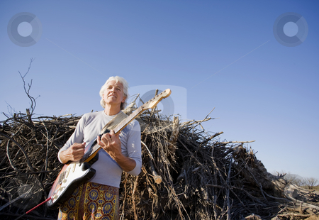 To use this stock image in your creative project, please select the size you need over to the right and click the "Add to Cart" button.
Your downloaded image will come with the Cutcaster watermark removed so don’t worry about the watermark you see on this page. Electric Guitar Player Outdoors stock photo, Electric Gutiar Player in Front of a Big Pile of Wood by Scott Griessel