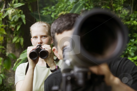 To use this stock image in your creative project, please select the size you need over to the right and click the "Add to Cart" button.
Your downloaded image will come with the Cutcaster watermark removed so don’t worry about the watermark you see on this page. Pretty Woman with Binoculars and Man with Telescope in Jungle stock photo, Pretty Woman with Binoculars and Man with Telescope in Rain Forest Jungle by Scott Griessel