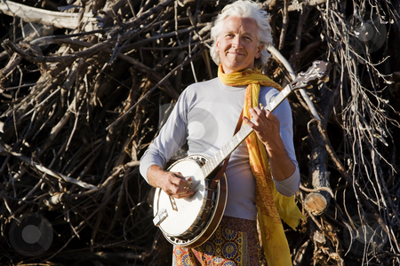 To use this stock image in your creative project, please select the size you need over to the right and click the "Add to Cart" button.
Your downloaded image will come with the Cutcaster watermark removed so don’t worry about the watermark you see on this page. Banjo Player stock photo, Banjo Player in Front of a Big Pile of Wood by Scott Griessel