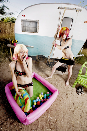 To use this stock image in your creative project, please select the size you need over to the right and click the "Add to Cart" button.
Your downloaded image will come with the Cutcaster watermark removed so don’t worry about the watermark you see on this page. Woman attempts to puncture her friends playpool stock photo, Woman attempts to puncture her friends playpool with a pitchfork by Scott Griessel