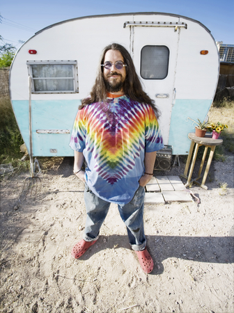 To use this stock image in your creative project, please select the size you need over to the right and click the "Add to Cart" button.
Your downloaded image will come with the Cutcaster watermark removed so don’t worry about the watermark you see on this page. Man in Front of a Trailer stock photo, Friendly Hippie with Long Hairin Front of His Trailer by Scott Griessel