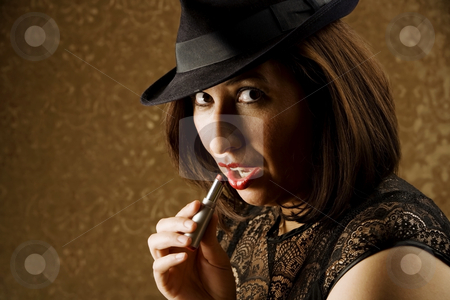 To use this stock image in your creative project, please select the size you need over to the right and click the "Add to Cart" button.
Your downloaded image will come with the Cutcaster watermark removed so don’t worry about the watermark you see on this page. Hispanic Woman Applying Makeup stock photo, Pretty Hispanic Woman in a Fedora Applying Lipstick by Scott Griessel