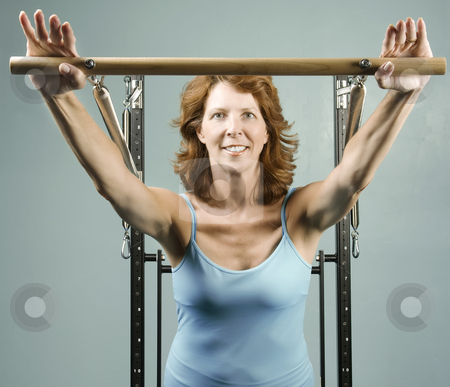 To use this stock image in your creative project, please select the size you need over to the right and click the "Add to Cart" button.
Your downloaded image will come with the Cutcaster watermark removed so don’t worry about the watermark you see on this page. Woman doing a strength workout stock photo, Woman using gym equipment to do a strength workout by Scott Griessel