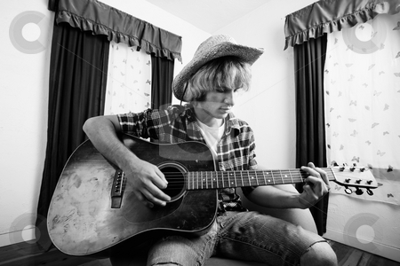 To use this stock image in your creative project, please select the size you need over to the right and click the "Add to Cart" button.
Your downloaded image will come with the Cutcaster watermark removed so don’t worry about the watermark you see on this page. Young Guitar Player stock photo, Young musician with an old guitar in an empty room by Scott Griessel