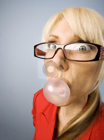 To use this stock image in your creative project, please select the size you need over to the right and click the "Add to Cart" button.
Your downloaded image will come with the Cutcaster watermark removed so don’t worry about the watermark you see on this page. Woman in red blowing a bubble stock photo, Woman in red with glasses blowing a bubble by Scott Griessel