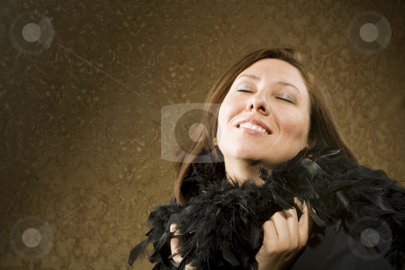 To use this stock image in your creative project, please select the size you need over to the right and click the "Add to Cart" button.
Your downloaded image will come with the Cutcaster watermark removed so don’t worry about the watermark you see on this page. Pretty Hispanic Woman Wearing Feathers stock photo, Pretty Hispanic Woman Wearing a Feather Boa in front of Gold Wallpaper by Scott Griessel