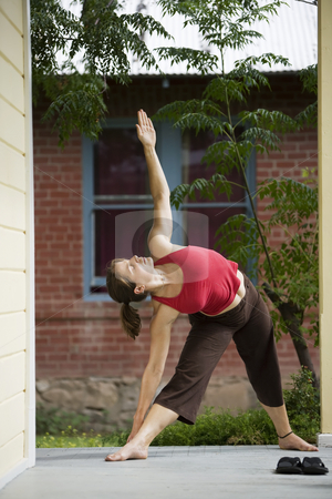 To use this stock image in your creative project, please select the size you need over to the right and click the "Add to Cart" button.
Your downloaded image will come with the Cutcaster watermark removed so don’t worry about the watermark you see on this page. Yoga triangle pose stock photo, Pretty Young Woman doing Yoga on a Porch by Scott Griessel