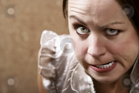 To use this stock image in your creative project, please select the size you need over to the right and click the "Add to Cart" button.
Your downloaded image will come with the Cutcaster watermark removed so don’t worry about the watermark you see on this page. Glaring Young Woman stock photo, Young woman making stern face in front of a gold wallpaper background by Scott Griessel