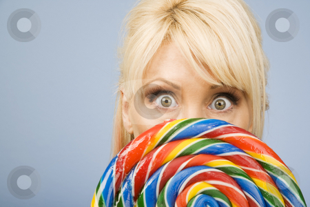 To use this stock image in your creative project, please select the size you need over to the right and click the "Add to Cart" button.
Your downloaded image will come with the Cutcaster watermark removed so don’t worry about the watermark you see on this page. Woman with a lollipop stock photo, Woman holding a big colorful lollipop by Scott Griessel