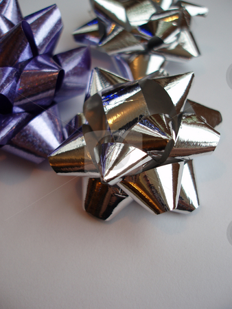 To use this stock image in your creative project, please select the size you need over to the right and click the "Add to Cart" button.
Your downloaded image will come with the Cutcaster watermark removed so don’t worry about the watermark you see on this page. Ribbon bows stock photo, Silver and purple present wrapping ribbons by Stephen Gibson