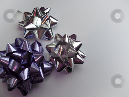 To use this stock image in your creative project, please select the size you need over to the right and click the "Add to Cart" button.
Your downloaded image will come with the Cutcaster watermark removed so don’t worry about the watermark you see on this page. Ribbon bows stock photo, Silver and purple present wrapping ribbons by Stephen Gibson