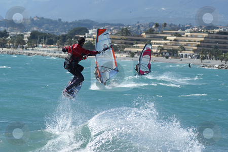 To use this stock image in your creative project, please select the size you need over to the right and click the "Add to Cart" button.
Your downloaded image will come with the Cutcaster watermark removed so don’t worry about the watermark you see on this page. Jump in Kite surf stock photo, Kiteboarder taking off for a jump in front of windsurfer by Serge VILLA